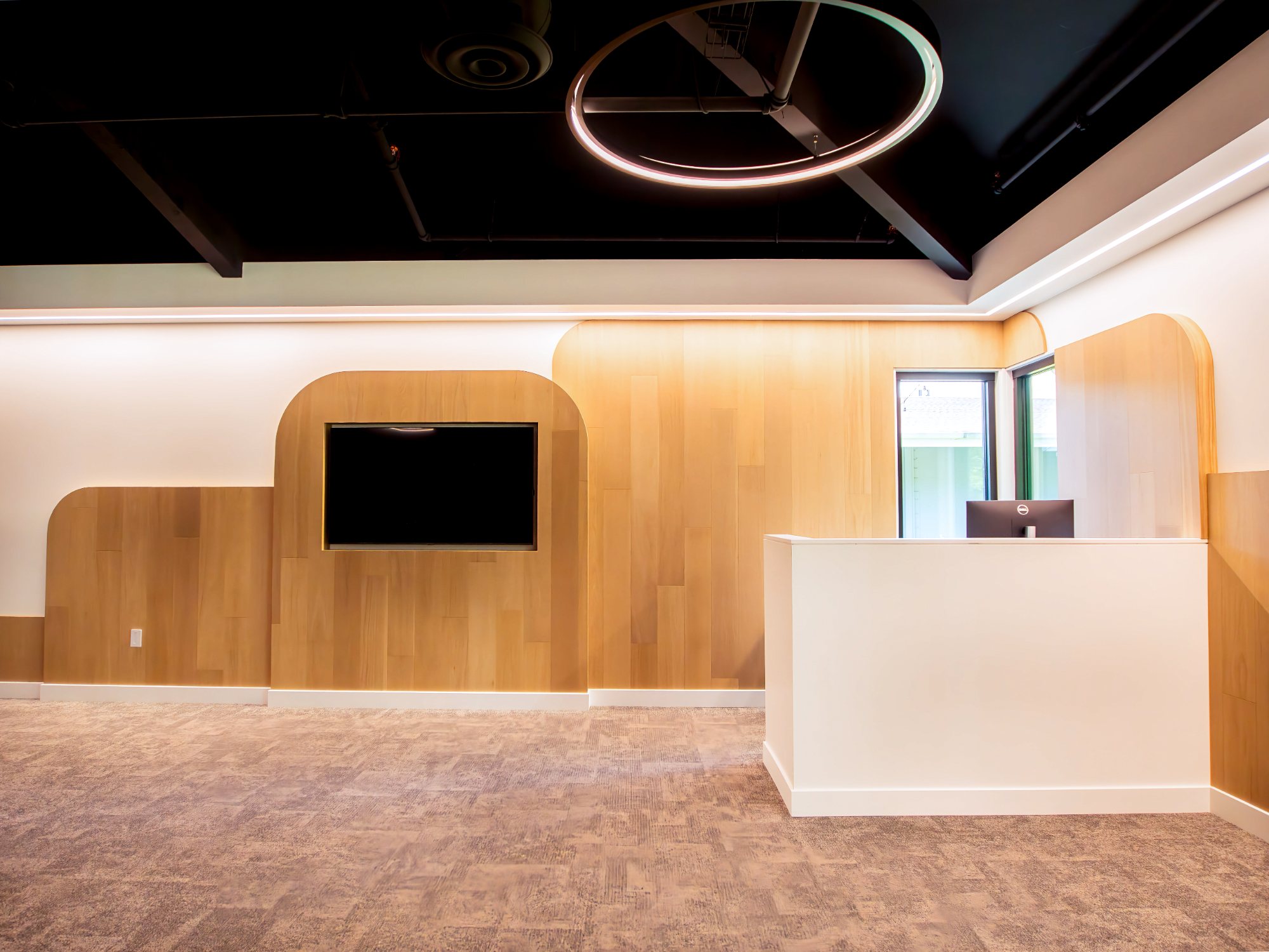 Venture Christian Church Kids Area, check-in desk with curved wood paneling